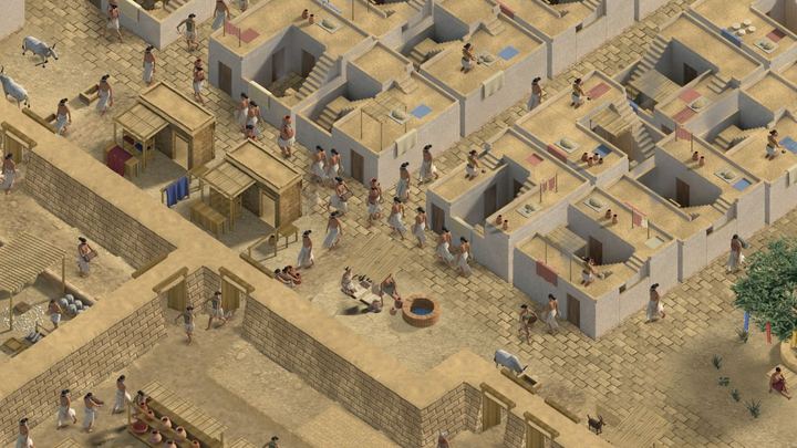 A crowded street of plastered courtyard houses with cloth stalls and a well.