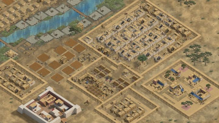 A whole walled town seen from above: river fields, craft quarters, houses and a white precinct.